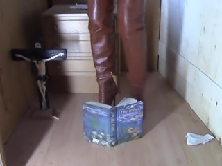 Sexy thigh-high brown and black boots on the bible