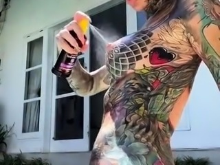 Webcam model showing off her amazing tattooed body outside